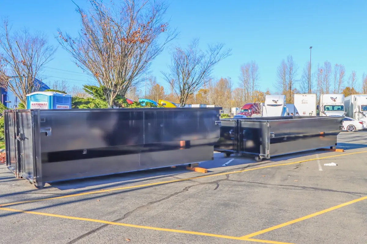 Professional dumpster rental service with roll-off container on residential driveway in Coal